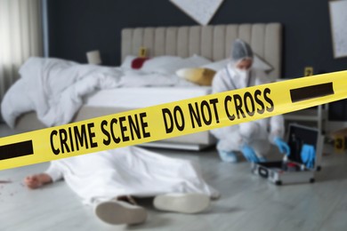 Yellow tape blocking way to crime scene. Criminologist working in room