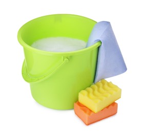 Photo of Green bucket with detergent, rag and sponges on white background