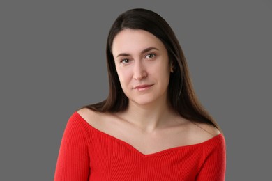 Photo of Portrait of beautiful young woman on grey background