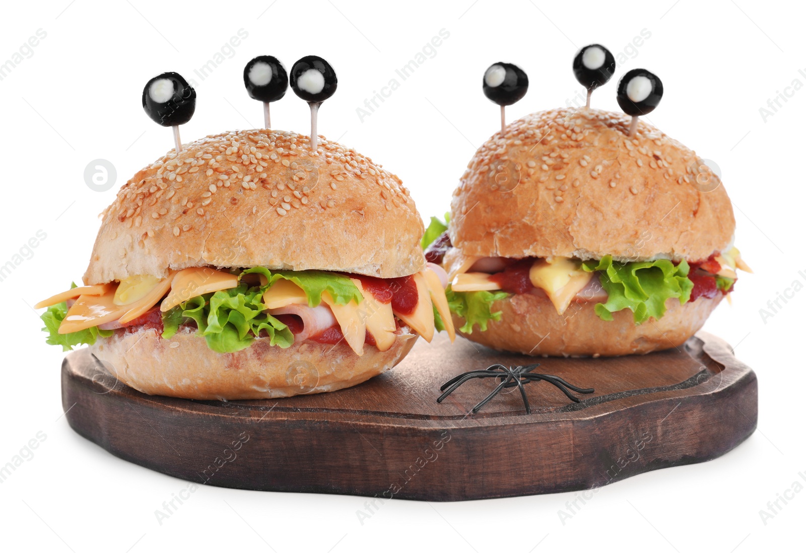 Photo of Cute monster burgers on white background. Halloween party food