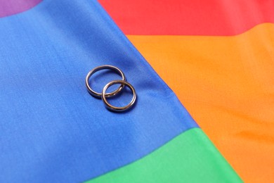 Photo of Wedding rings on rainbow LGBT flag, closeup