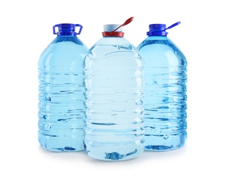 Photo of Large plastic bottles with pure water on white background