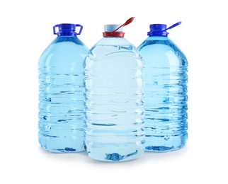 Large plastic bottles with pure water on white background