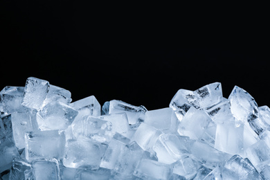 Photo of Ice cubes on black background, closeup view
