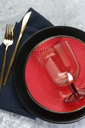 Photo of Clean plates, glass, cutlery and napkin on table, top view