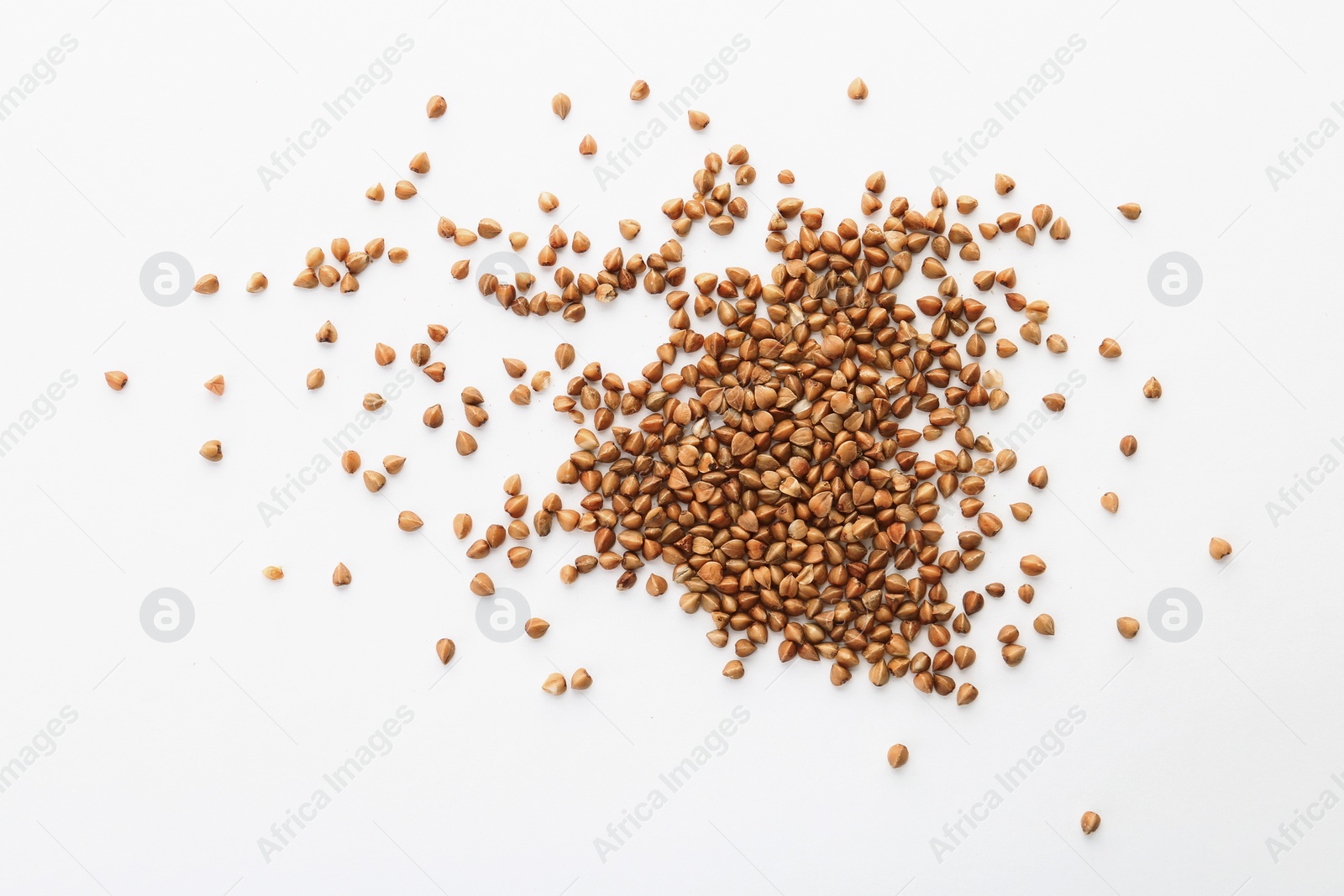 Photo of Raw buckwheat on white background. Healthy grains and cereals