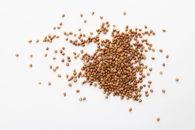 Photo of Raw buckwheat on white background. Healthy grains and cereals