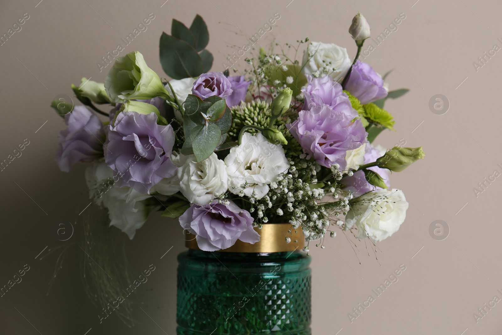 Photo of Beautiful bouquet with Eustoma flowers on beige background, closeup