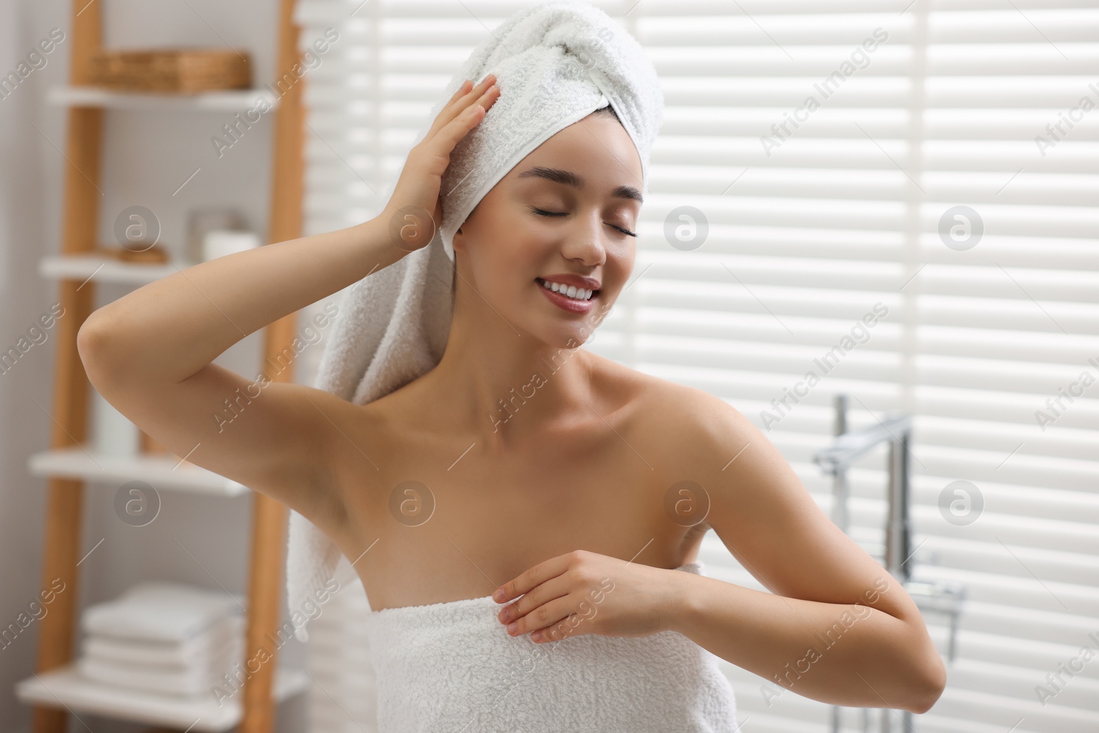 Photo of Portrait of smiling woman after shower in bathroom