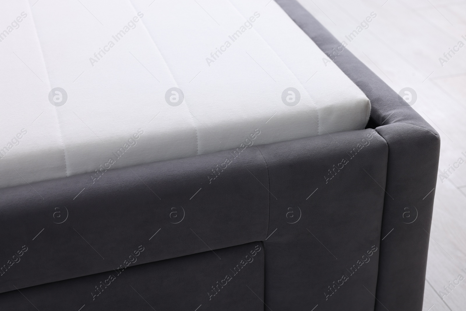 Photo of Comfortable bed with new soft mattress indoors