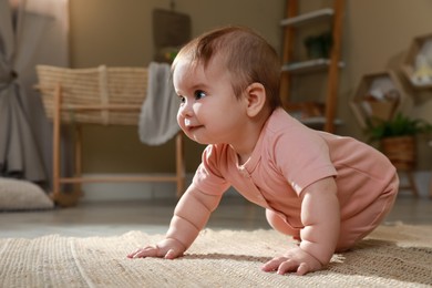Photo of Cute baby crawling on floor at home. Space for text