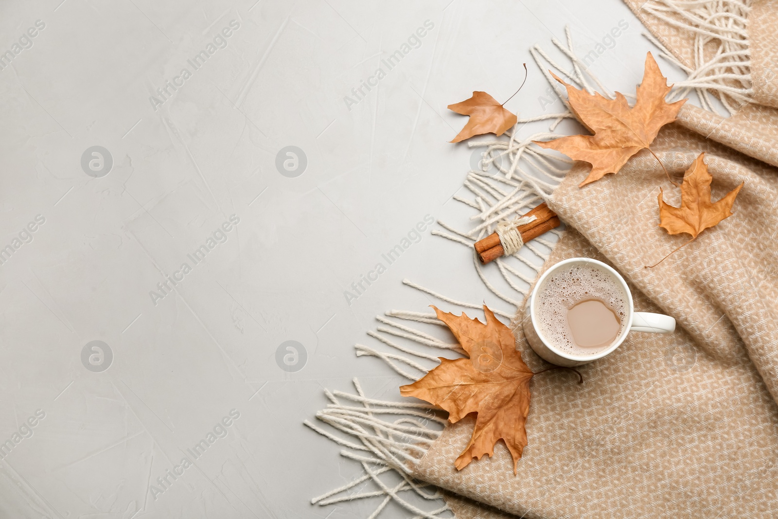 Photo of Flat lay composition with coffee and warm plaid on light table, space for text