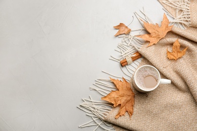 Photo of Flat lay composition with coffee and warm plaid on light table, space for text