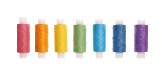 Photo of Set of colorful sewing threads on white background
