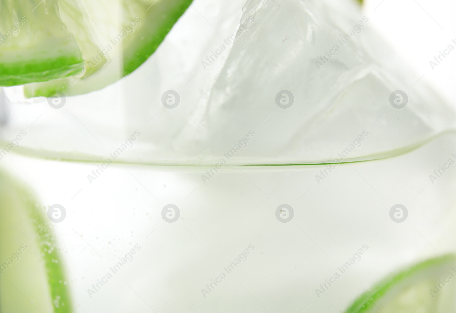 Photo of Drink with lime and ice cubes, closeup
