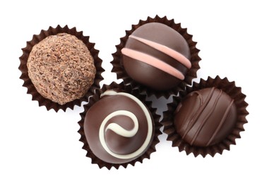 Photo of Many different delicious chocolate truffles on white background, top view