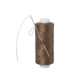 Photo of Spool of brown sewing thread with needle isolated on white