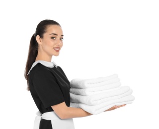 Young chambermaid with stack of clean towels on white background