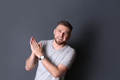 Photo of Portrait of handsome laughing man on grey background. Space for text