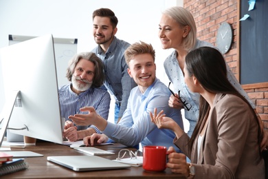 Photo of Business people discussing work matters at table in office. Professional communication