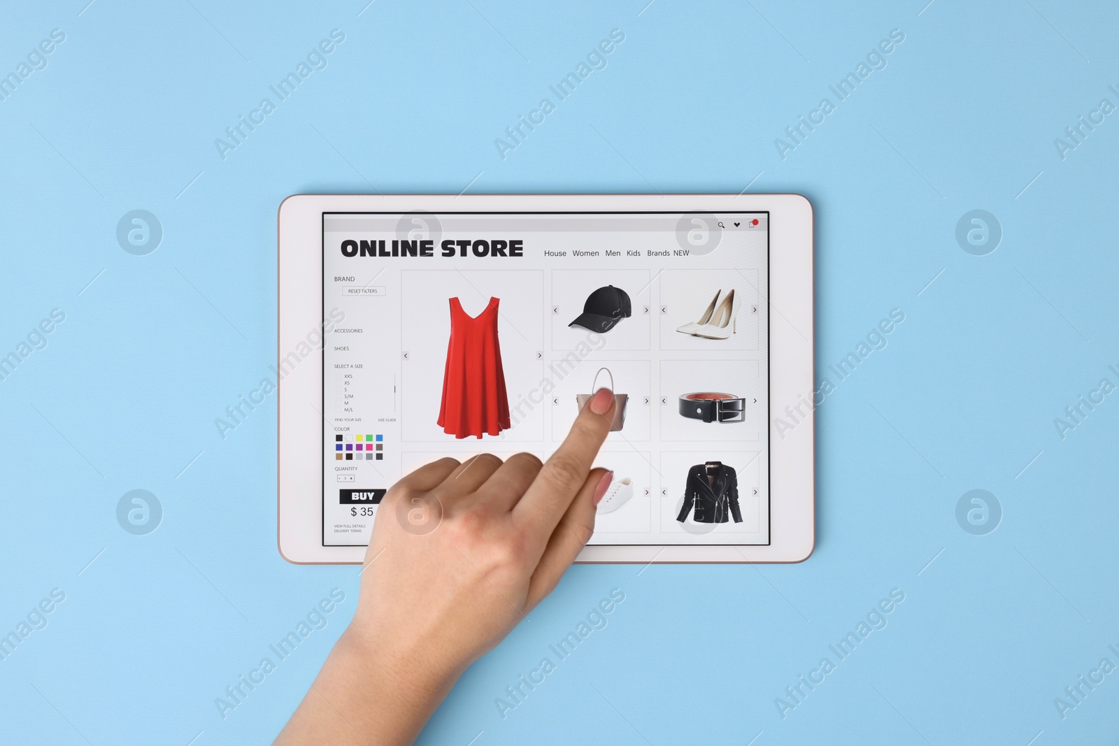 Photo of Woman with tablet shopping online on light blue background, top view