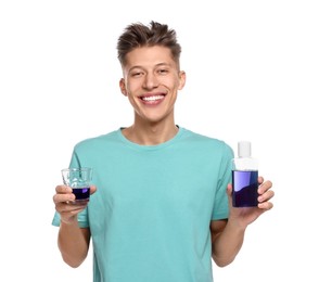 Young man with mouthwash on white background