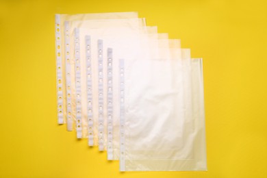 Punched pockets on yellow background, flat lay