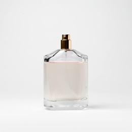 Transparent bottle of perfume on white background