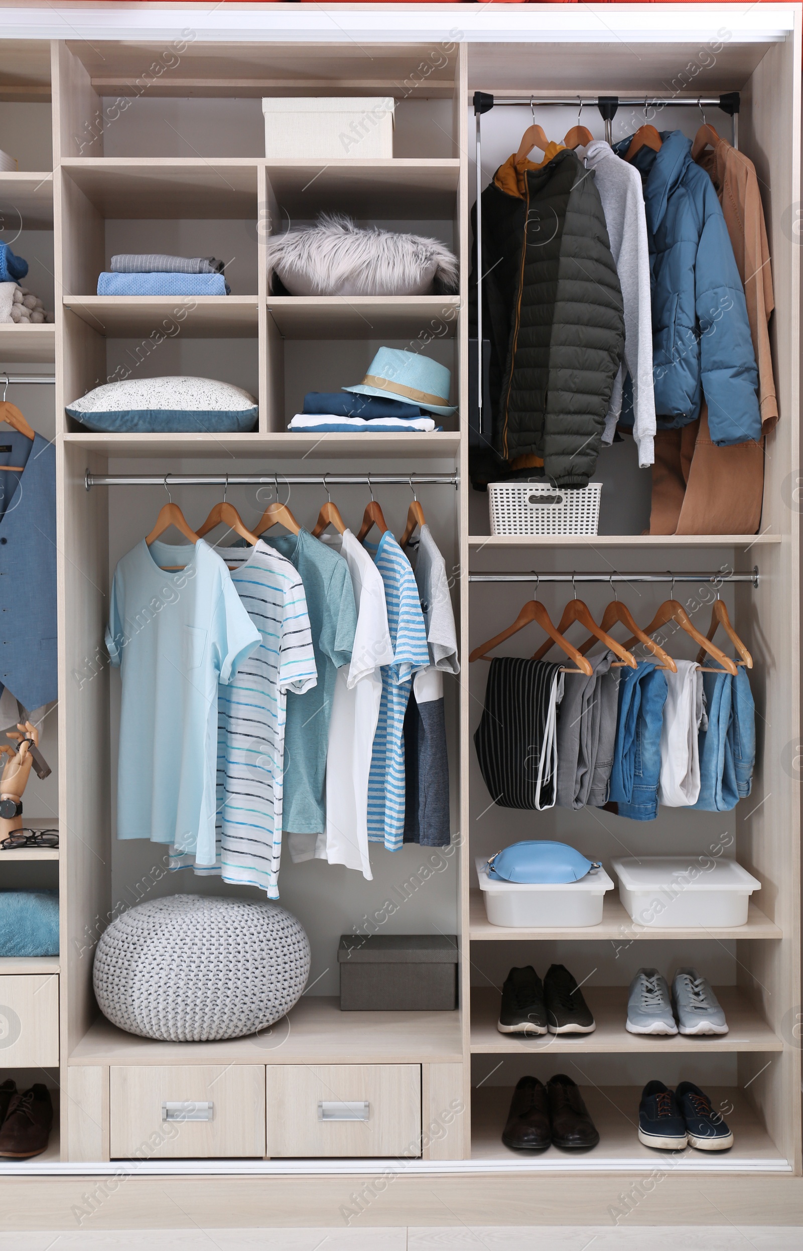 Photo of Stylish clothes, shoes and home stuff in large wardrobe closet