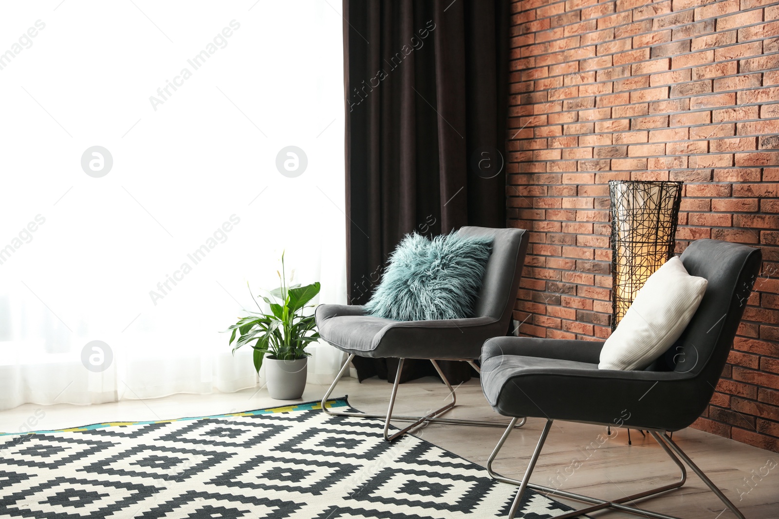 Photo of Comfortable chairs near window with elegant curtains in room. Space for text