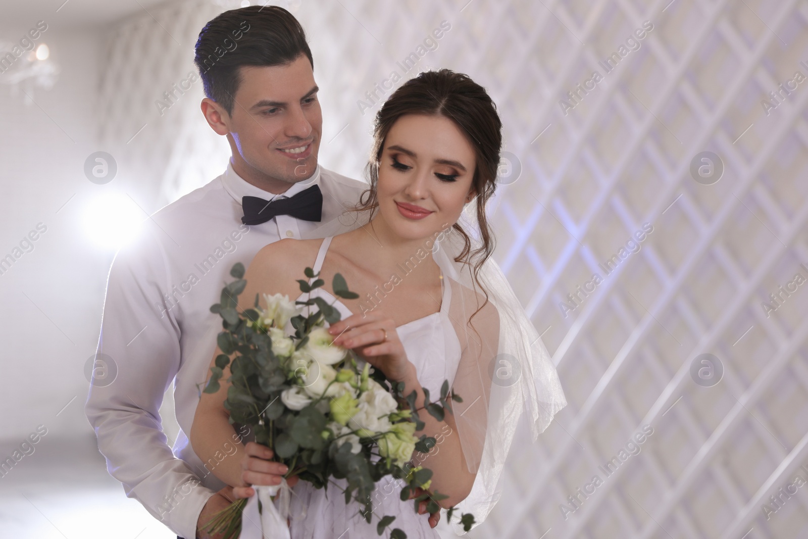 Photo of Happy newlywed couple together in festive hall