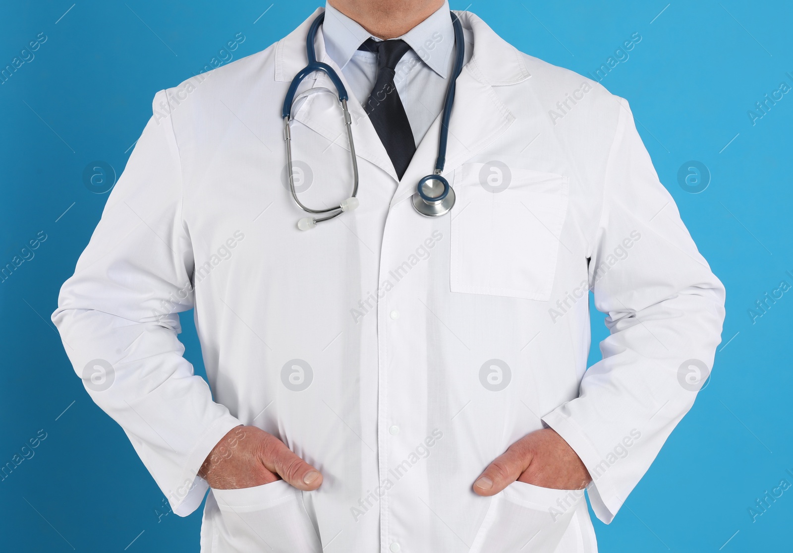 Photo of Senior doctor with stethoscope on blue background, closeup