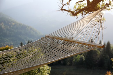 Comfortable net hammock in mountains on sunny day, closeup