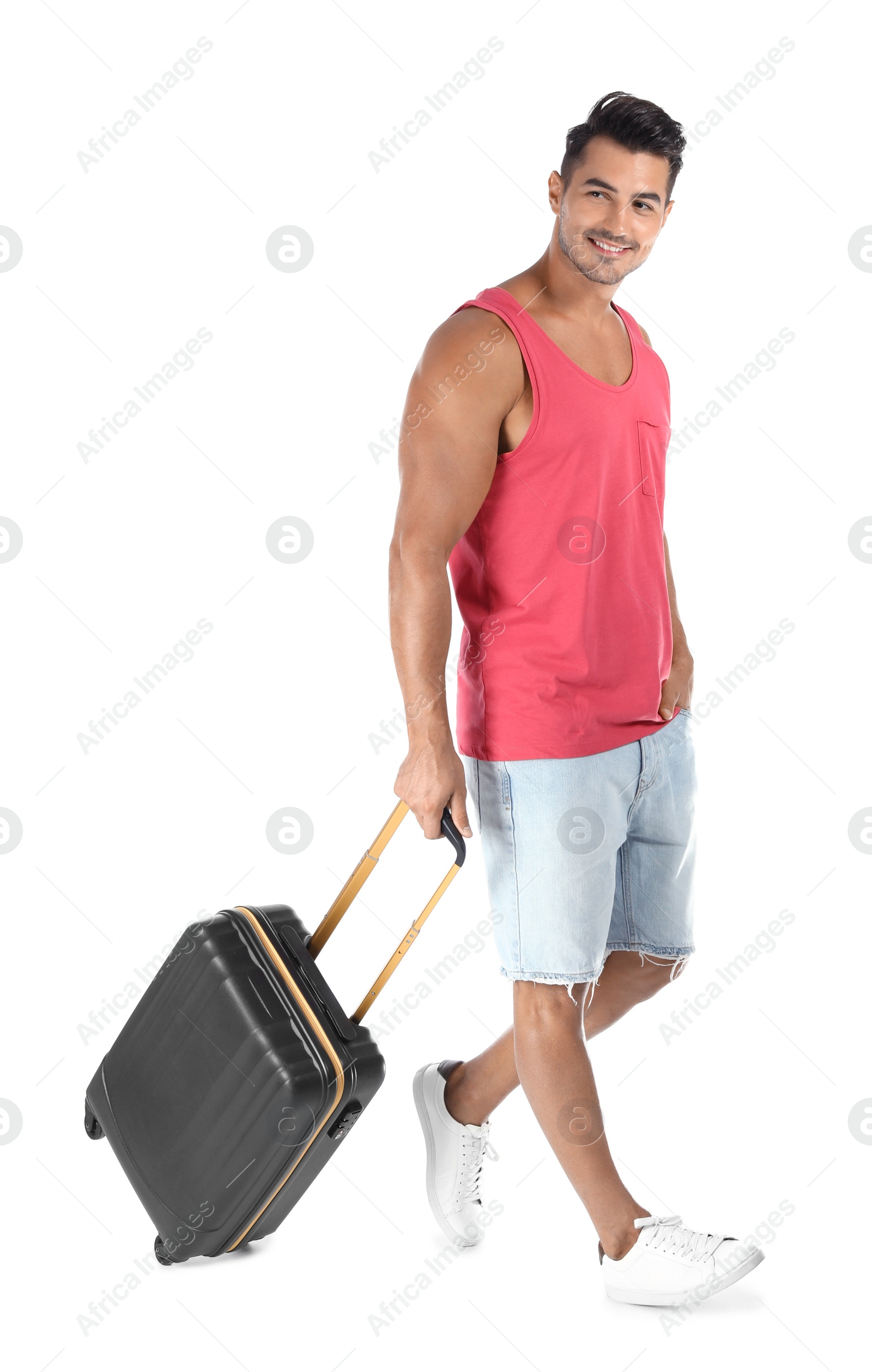 Photo of Young man walking with suitcase on white background