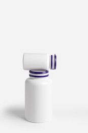 Photo of Closed plastic medicine bottles on white background. Medicament