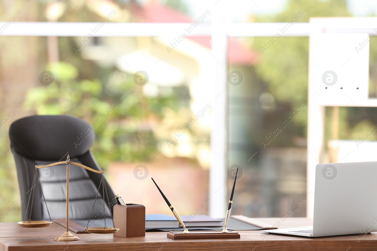 Photo of Table with scales of justice in lawyer's office