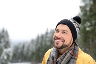 Photo of Man in warm clothes outdoors, space for text. Winter vacation