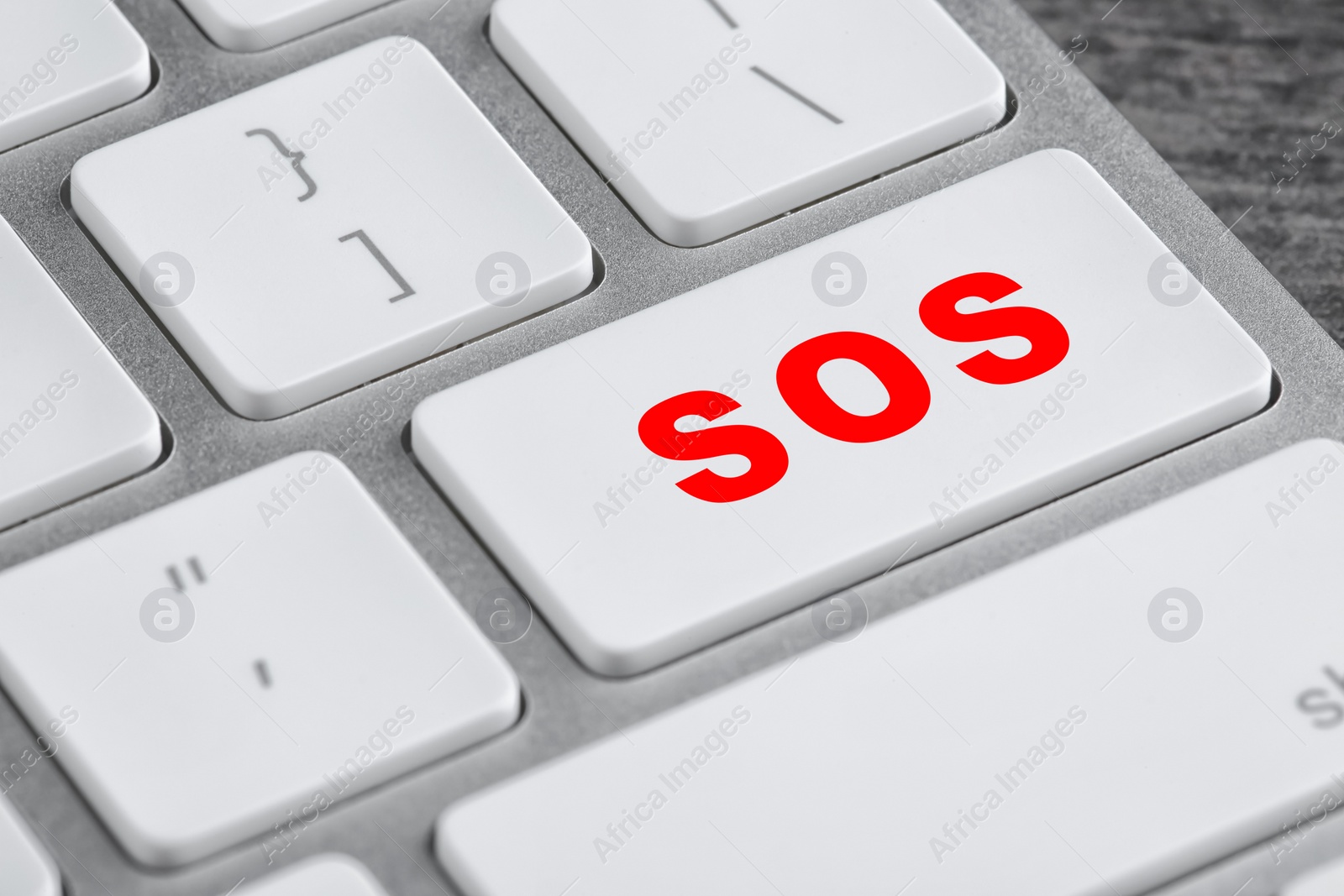 Image of Button with word SOS on computer keyboard, closeup. Rescue concept