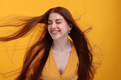 Photo of Portrait of smiling woman on yellow background