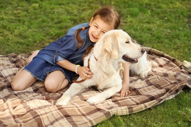 Cute little child with his pet in green park