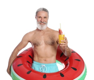 Shirtless man with inflatable ring and glass of cocktail on white background