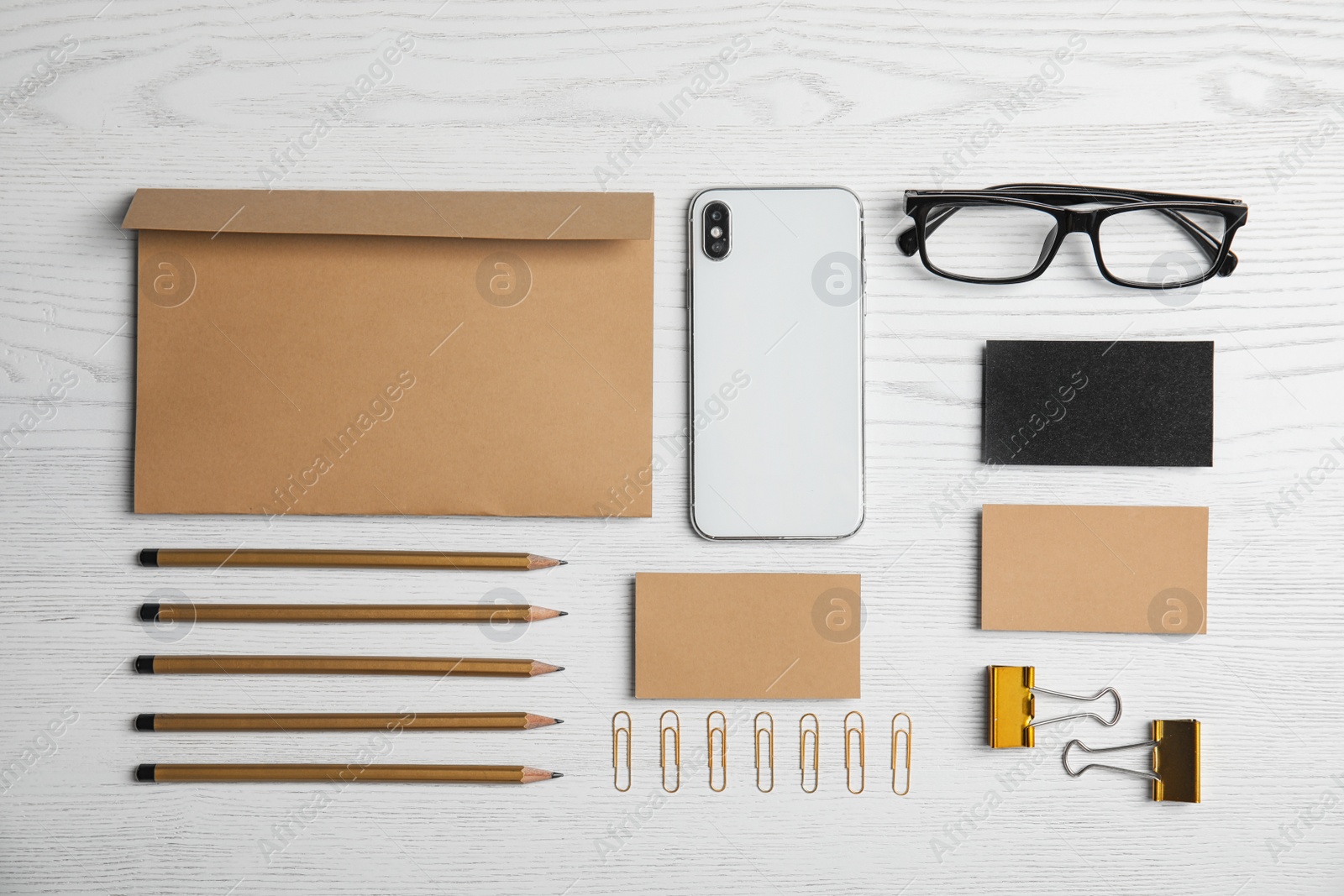 Photo of Flat lay composition with stationery on white wooden background. Mock up for design