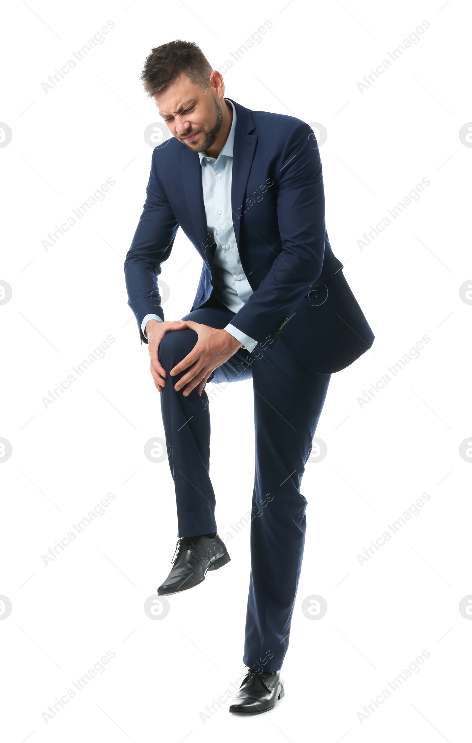Photo of Full length portrait of businessman having knee problems on white background
