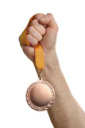 Photo of Man holding bronze medal on white background, closeup. Space for design