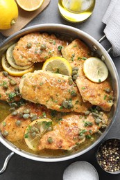 Photo of Delicious chicken piccata on grey table, flat lay