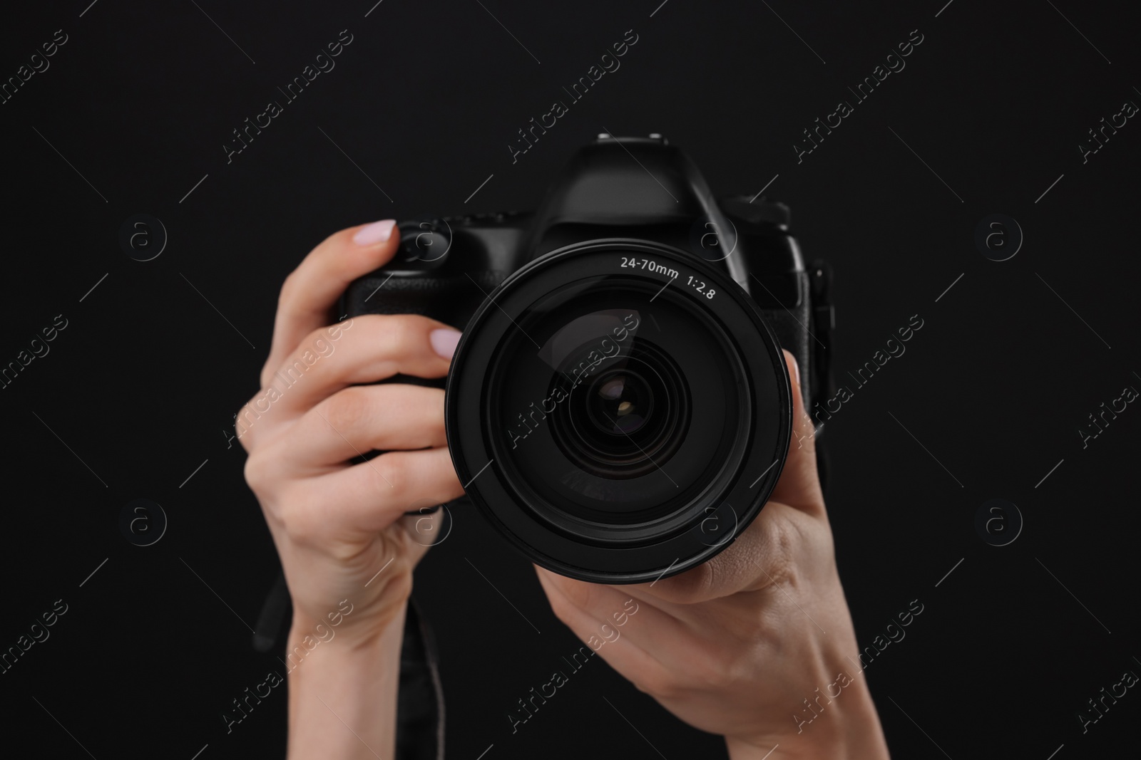 Photo of Photographer with camera on black background, closeup