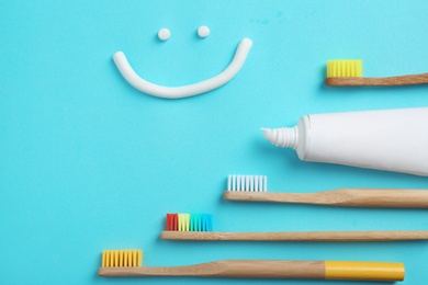 Photo of Flat lay composition with smiling face made of toothpaste on color background