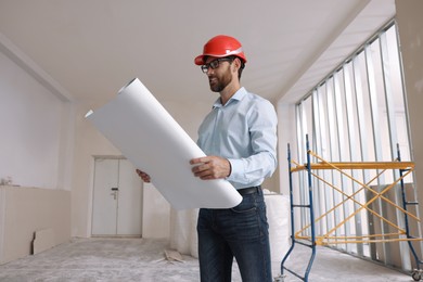 Photo of Professional engineer in hard hat with draft indoors