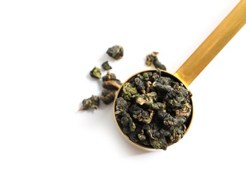 Photo of Scoop with Tie Guan Yin Oolong tea on white background, top view