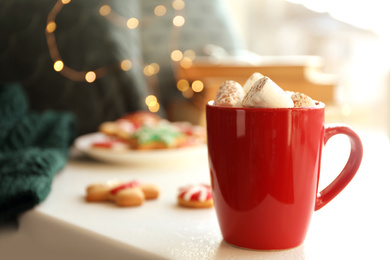 Cup of delicious hot cocoa with marshmallows on white table. Winter drink